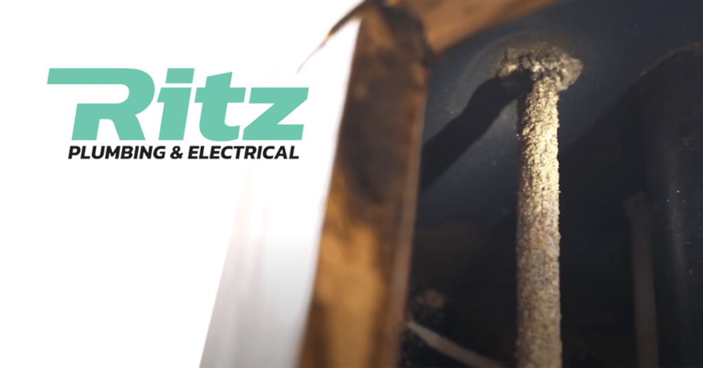 The Ritz P&E logo in front of a hot water anode covered in scale.